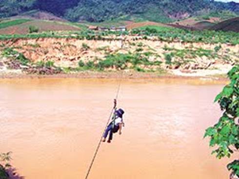 Em Trần Thị Ánh Tuyết  một mình đu dây qua sông để đén trường. Ảnh: Tuổi trẻ